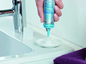 Rogaine Women’s 5% Minoxidil Foam dispensed onto a surface showing lightweight foam texture