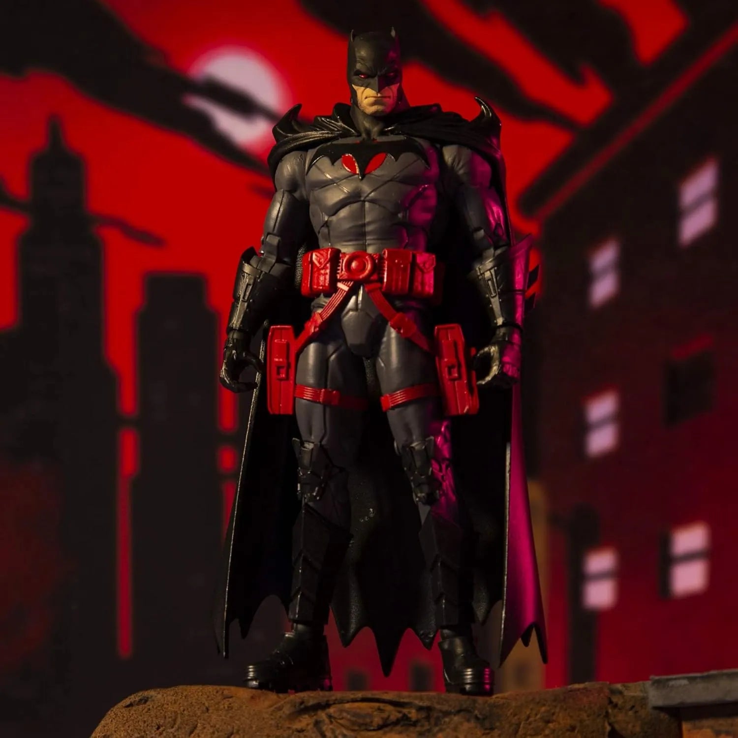 McFarlane Toys DC Batman Flashpoint 7-inch action figure posed against red Gotham city background.